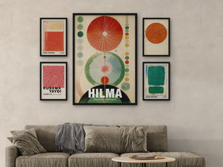 Gallery wall above a sofa: a 70x100 Hilma print flanked by four A3 prints in black frames