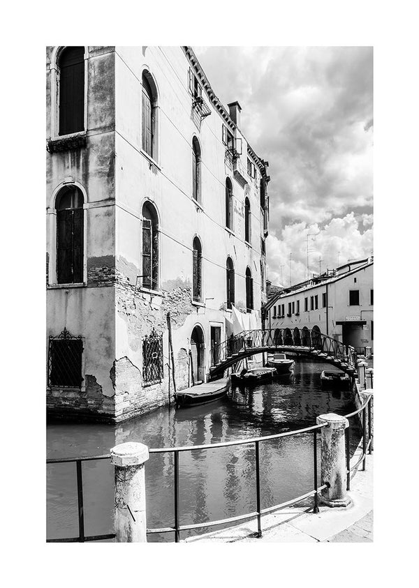 Black and white poster of a canal, bridge, and historic buildings in a European city.