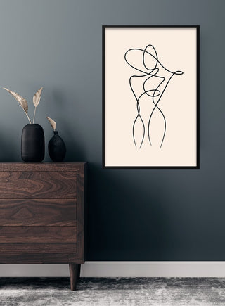 Minimalist line art poster of a woman, framed and hanging on a dark wall above a wooden dresser.