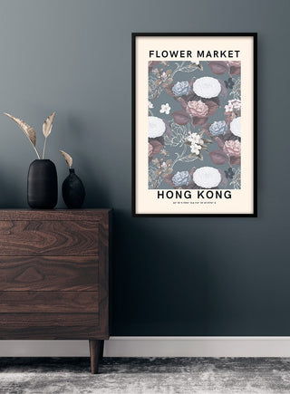 Framed "Flower Market - Hong Kong" poster with floral design hanging on a dark wall above a wooden dresser.