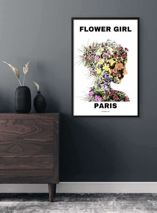 Framed poster of a woman’s silhouette filled with colorful flowers, titled "Flower Girl Paris," on a modern wall.
