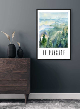 Green Paysage Plakat on a gray wall above a wooden dresser, featuring watercolor mountains and trees.