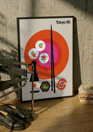 Tokyo 65 by Bo Lundberg in a black frame leaning against a concrete wall by a steel chair