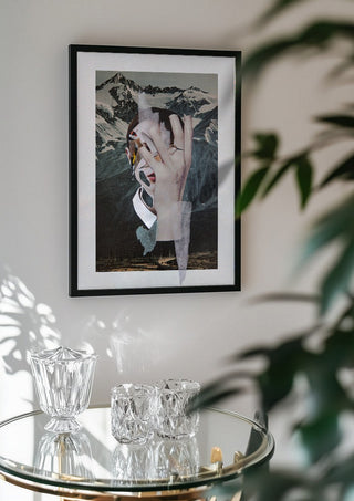 Birdie by Rocio Montoya in a black frame above a glass table with crystal glassware