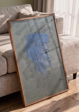 Portrait in Blue by Allheartsportraits in a walnut frame leaning against a grey sofa