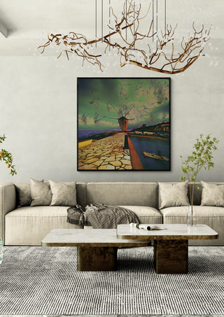 Garitsa Windmill by Pelecan Schneider in a black frame above a beige sofa under a branch chandelier