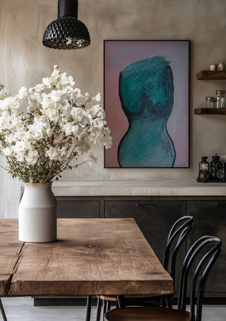 Kroppen by RR in a black frame above a rustic table with white flowers