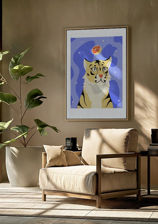Grrrapefruit by Jakob Falkenberg framed above a beige armchair beside a potted plant