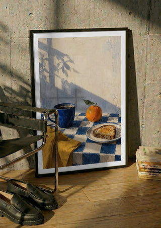Blue Hour Breakfast by Matthews Gallerie in a black frame leaning against a concrete wall by a steel chair