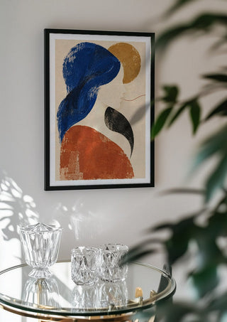 The Shape of Silence by Matthews Gallerie in a black frame above a glass table with crystal glassware