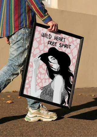 Wild heart, free spirit by Lisen Vennesland carried in a black frame along a sunny street