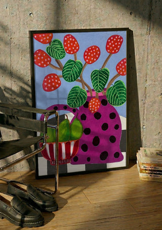 Sweet Pear by LGDyrby in a black frame leaning against a concrete wall by a steel chair