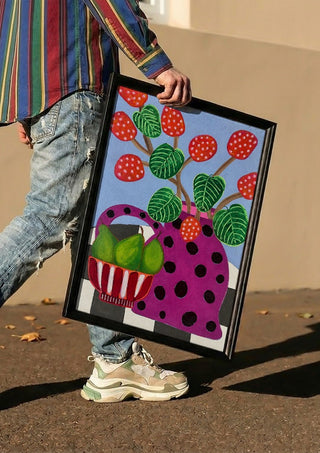 Sweet Pear by LGDyrby carried in a black frame along a sunny street