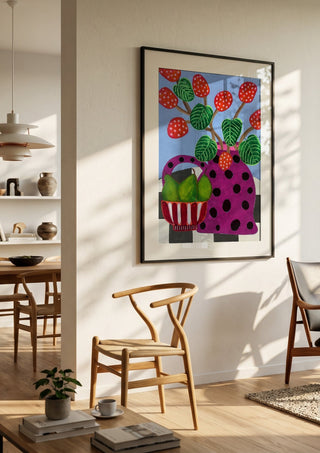 Sweet Pear by LGDyrby in a black frame in a bright dining room with wooden chairs