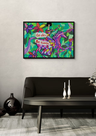 To Do: Be Iconic by Camilla Nilsson in a black frame above a dark sofa with candlesticks and a vase