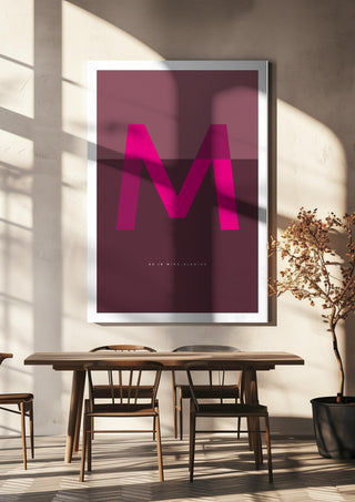 M as in Mind-blowing – Cerise by Quite Nice Prints hanging above a wooden dining table in warm sunlight