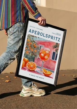 Il dolce far niente - Aperol by Ohkimiko carried in a black frame along a sunny street