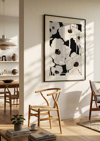 Abstract Flowers by ThingDesign in a black frame in a bright dining room with wooden chairs