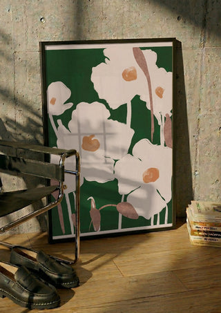 Abstract Flowers 9 by ThingDesign in a black frame leaning against a concrete wall by a steel chair