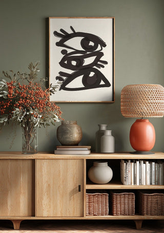 Abstract line art eyes 3 by ThingDesign above a wooden sideboard on a sage green wall