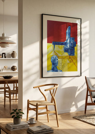 Facing the Monument by Linor Citaku in a black frame in a bright dining room with wooden chairs