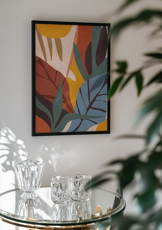 Abstract Art Jungle by ThingDesign in a black frame above a glass table with crystal glassware