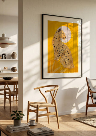 Leopard by ThingDesign in a black frame in a bright dining room with wooden chairs