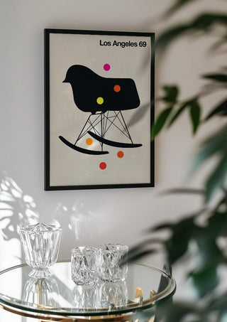 Los Angeles 69 by Bo Lundberg in a black frame above a glass table with crystal glassware