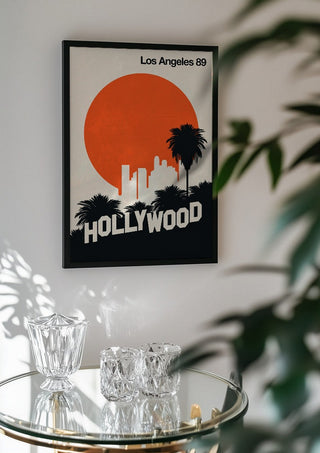 Los Angeles 89 by Bo Lundberg in a black frame above a glass table with crystal glassware