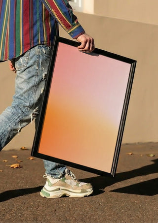 Sunset - cheerful, warm color gradient by Ohkimiko carried in a black frame along a sunny street