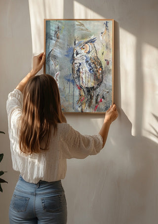 Owl by Lüba being hung on a sunlit wall