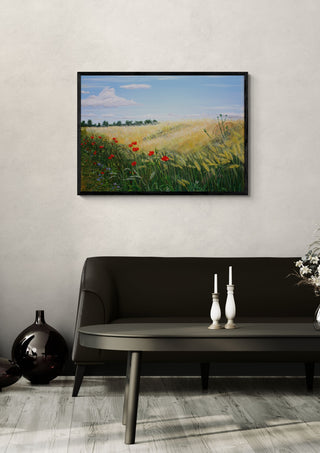 Summer by Juergen Duerrmann in a black frame above a dark sofa with candlesticks on a round table