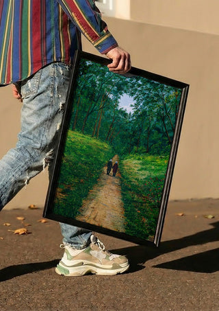 The way of live by Juergen Duerrmann carried in a black frame along a sunny street