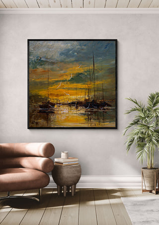 Evening Gold by Justyna Kopania in a black frame above a leather armchair beside a palm