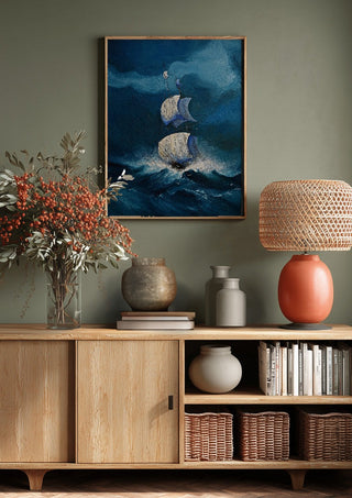 Sails in the Dark Swell by Justyna Kopania above a wooden sideboard on a sage green wall