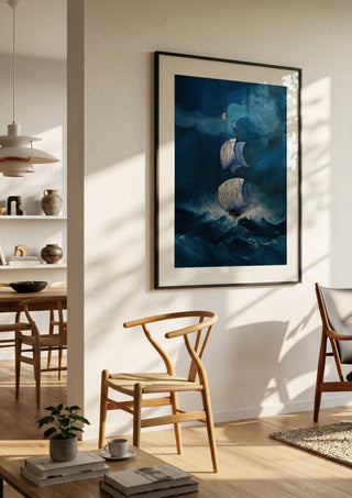 Sails in the Dark Swell by Justyna Kopania in a black frame in a bright dining room with wooden chairs
