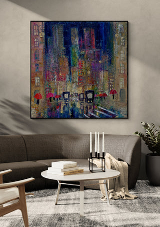 Rain on the Boulevard by Justyna Kopania in a black frame above a dark sofa with candlesticks on a round table