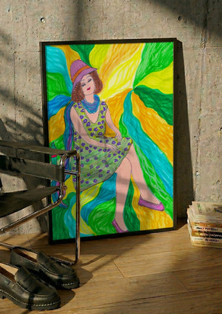 The Lilac Hat by Camilla Nilsson in a black frame leaning against a concrete wall by a steel chair
