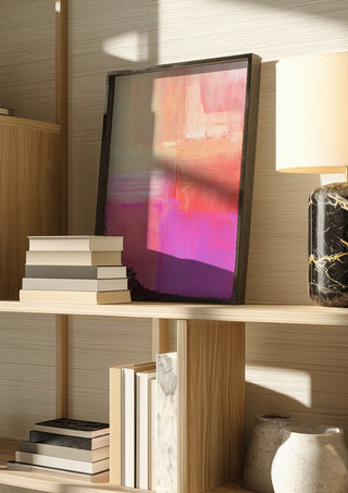 soft atmospheric composition by Iris Lehnhardt in a dark frame on a wooden shelf beside books and a lamp