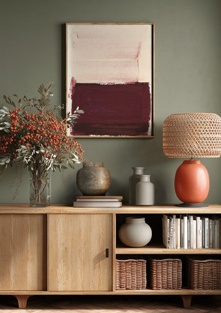 colorfields pale pink warm red by Iris Lehnhardt above a wooden sideboard on a sage green wall