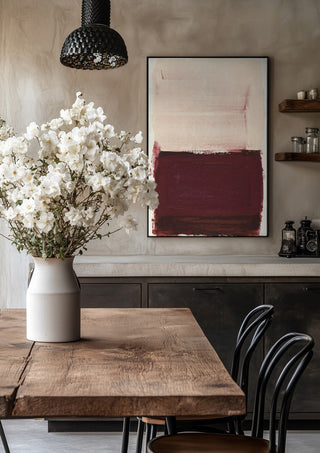 colorfields pale pink warm red by Iris Lehnhardt in a black frame above a rustic table with white flowers