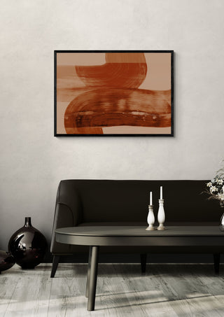abstract shapes autumn orange by Iris Lehnhardt in a black frame above a dark sofa with candlesticks on a round table