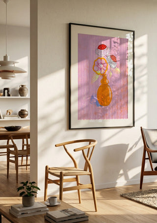 Flowers in an Orange Vase by Creationsbyeditabrus in a black frame in a bright dining room with wooden chairs