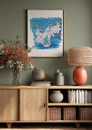 White Blooms on Blue by DNF above a wooden sideboard on a sage green wall