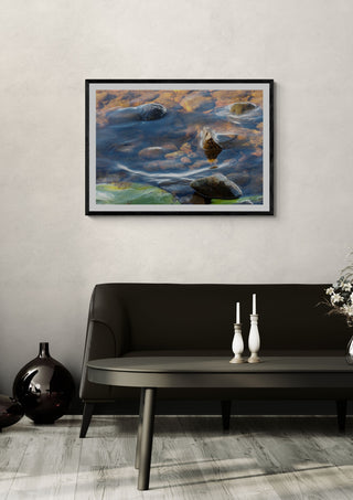 Sommar brus by Ljilja Marinic in a black frame on a pale wall above a dark sofa with candlesticks