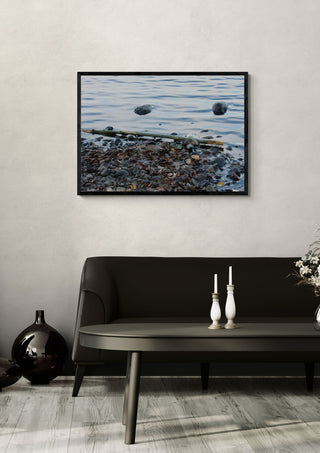 Sjöns puls by Ljilja Marinic in a black frame on a pale wall above a dark sofa with candlesticks