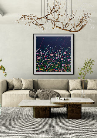 Thames Rain by Rebecca Wright in a black frame beneath a branch chandelier above a long beige sofa