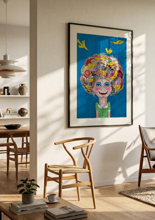 Pájaros en la cabeza by María Burgaz in a black frame in a bright dining room with wooden chairs