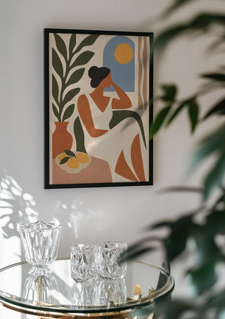 Contemplative Afternoon by TimlessArtworks in a black frame above a glass table with crystal glassware