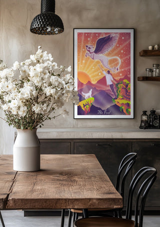 The Fool by Sciurus tarotus in a black frame above a rustic table with white flowers